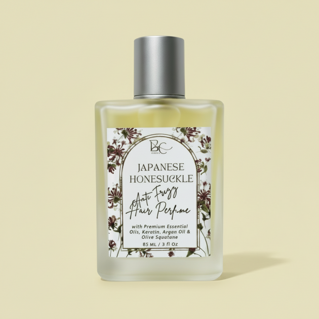 Bottle of luxury hair perfume with keratin, argan oil and Japanese Honeysuckle essential oil with floral label on a white background