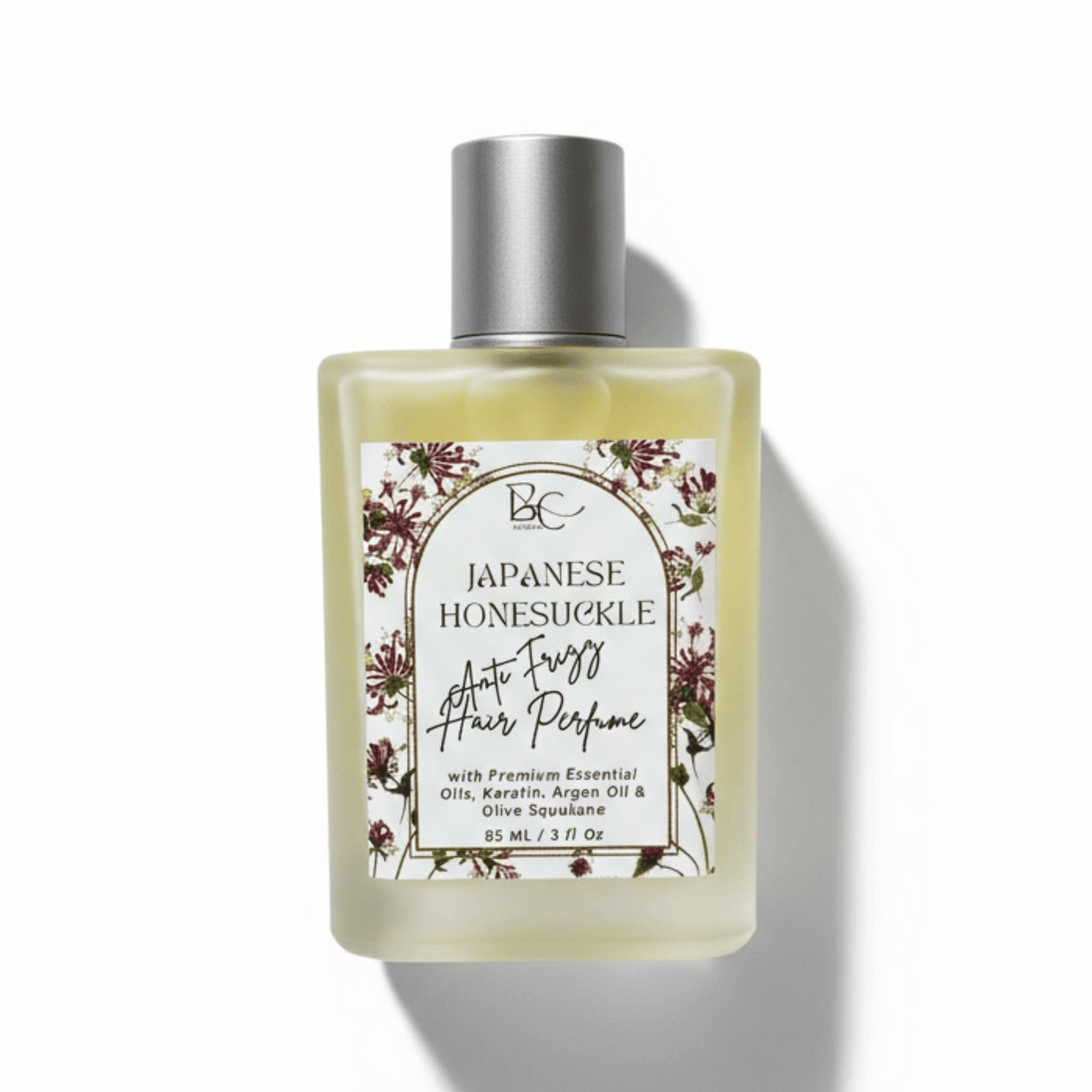 Bottle of 'Japanese Honeysuckle' hair perfume with essential oils, keratin and olive squalane with a white label on a white background