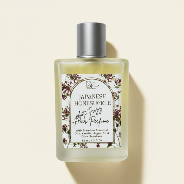 Bottle of 'Japanese Honeysuckle' hair perfume with essential oils, keratin and olive squalane with a white label on a white background