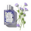luxury hair perfume with sweet pea essential oil, argan oil, keratin and olive squalane with floral labe and text Anti Frizz Hair perfume alongside sweet pea flowers on white background