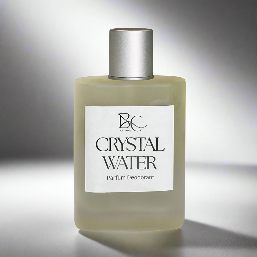 Glass perfume bottle with silver cap against light gray backdrop with soft shadows representing luxury men’s Australian made perfume.