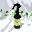 Bottle of natural magnesium oil Magnesium Oil Energise & Balance Spray – citrus and floral aromatherapy with a black spray nozzle on a light background