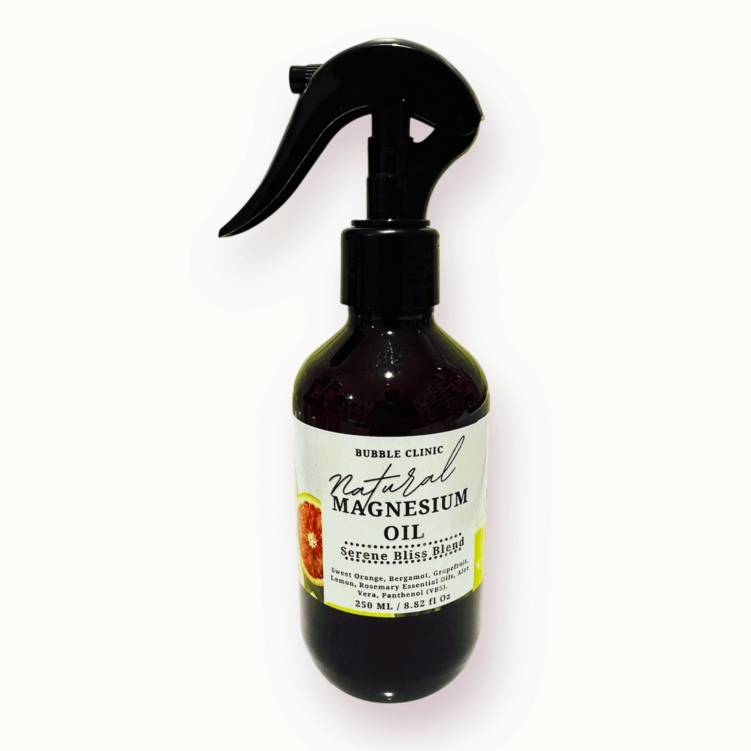 Bottle of natural magnesium oil with a black spray nozzle on a white background. the label has images of citrus slices representing the citrusy essenital oil blend.