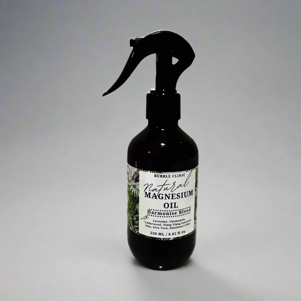 dark bottle of natural magnesium oil with with soothing lavender and chamomile for sleep against white background with shadow reflections from nature representing the best Australian Wellness Care.