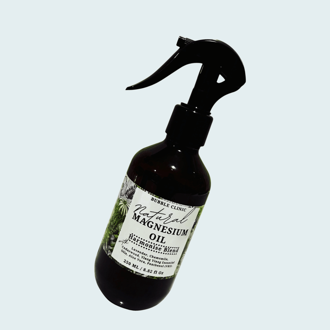 Bottle of natural magnesium oil sleep spray with a label highlighting natural ingredients and essential oil blend on a light gray background