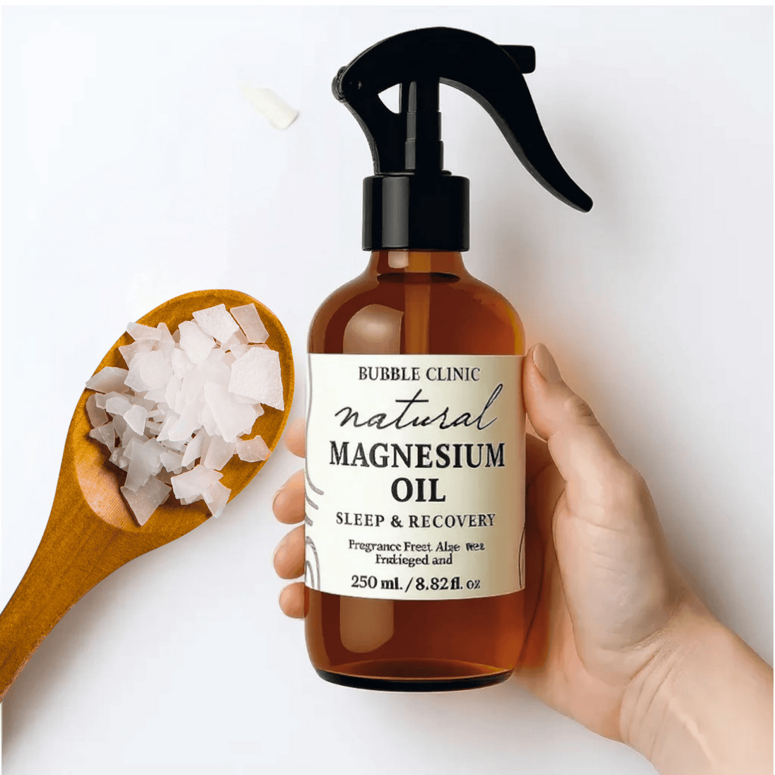 Bottle of natural magnesium oil with a label, held by a hand, next to a wooden spoon with magnesium flakes representing pure Australian Magnesium Oil