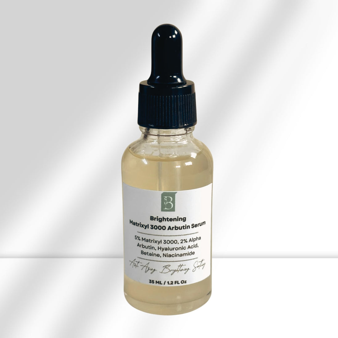 close up of brightening matrixyl 3000 and alpha arbutin serum showing label with natural ingredients for a brighter, youthful complexion including hyaluronic acid, betaine and niacinamide.