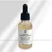 close up of environmentally friendly glass serum bottle of brightening and anti aging matrixyl 3000 and alpha arbutin serum against white background representing natural clean beauty.