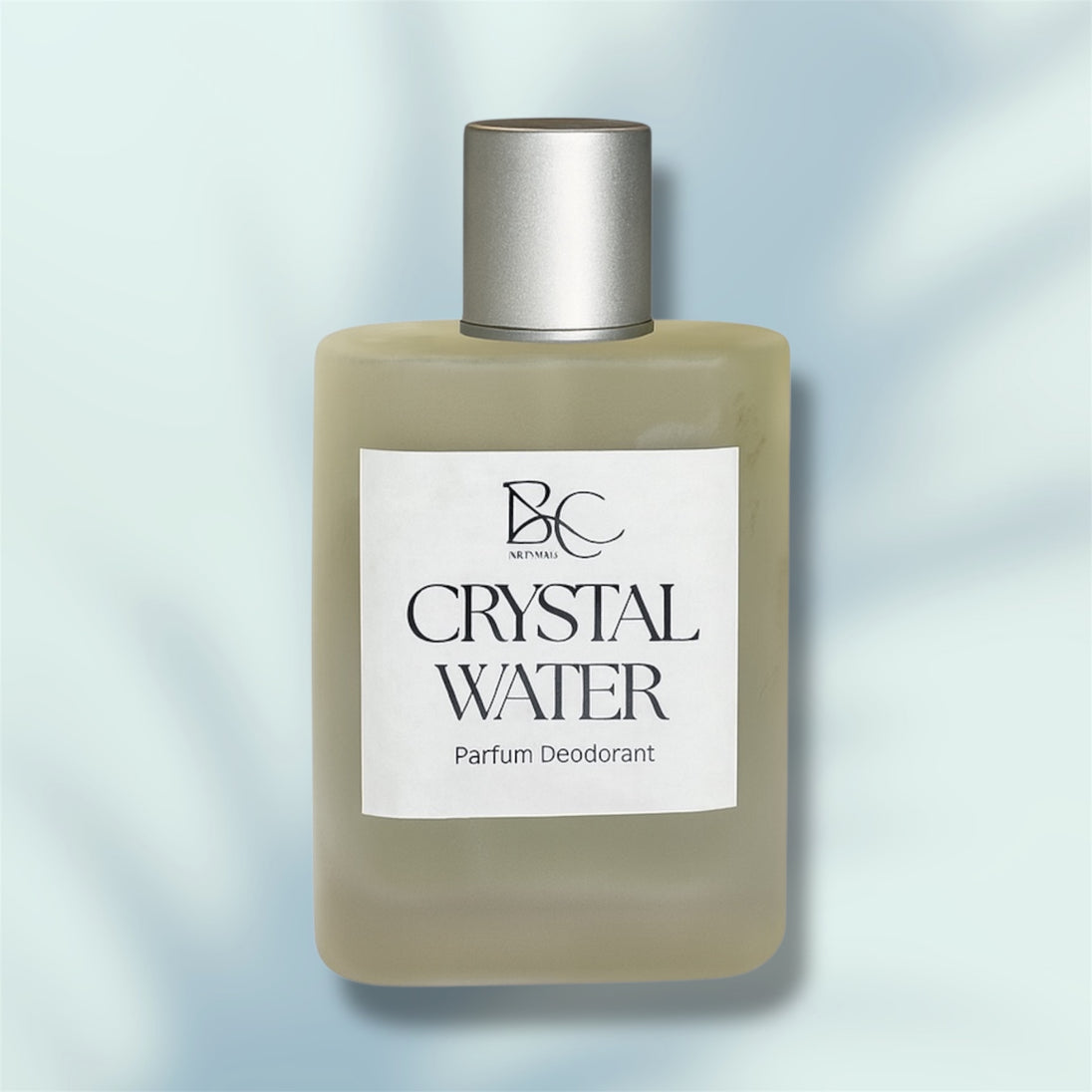 Bottle of Crystal Water parfum deodorant with a silver cap on a light blue background