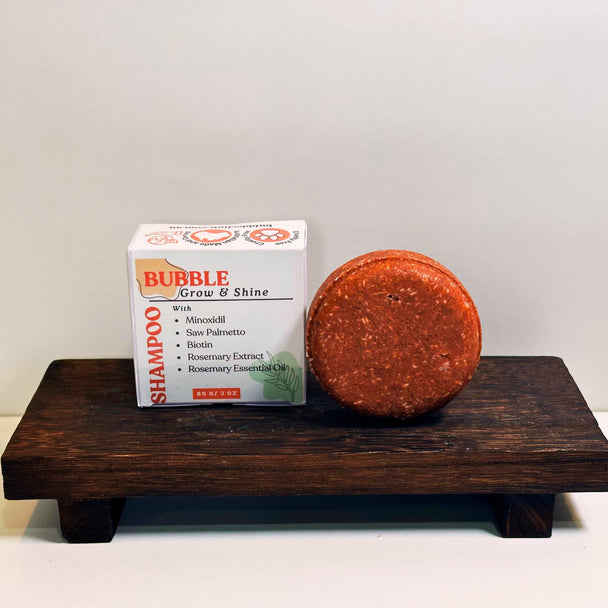 shampoo bar and package box pictured against light minimalist background representing natural Australian Haircare for hair growth.