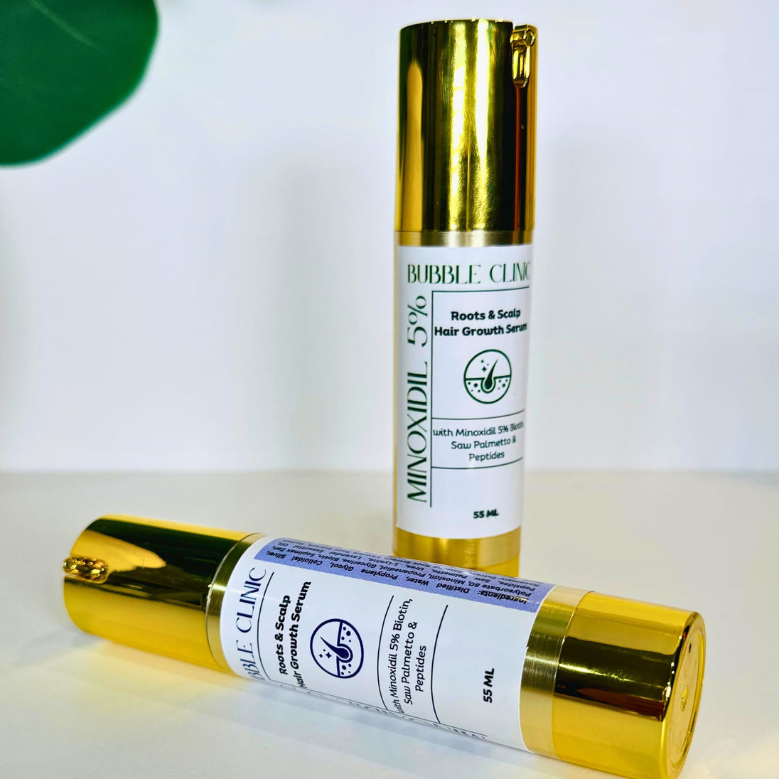 Close up front view of 2 options of minoxidil maximum strength serum with rosemary essential oil and extract and lavender essential oils with botanicals representing most powerful hair regrowth solutions.