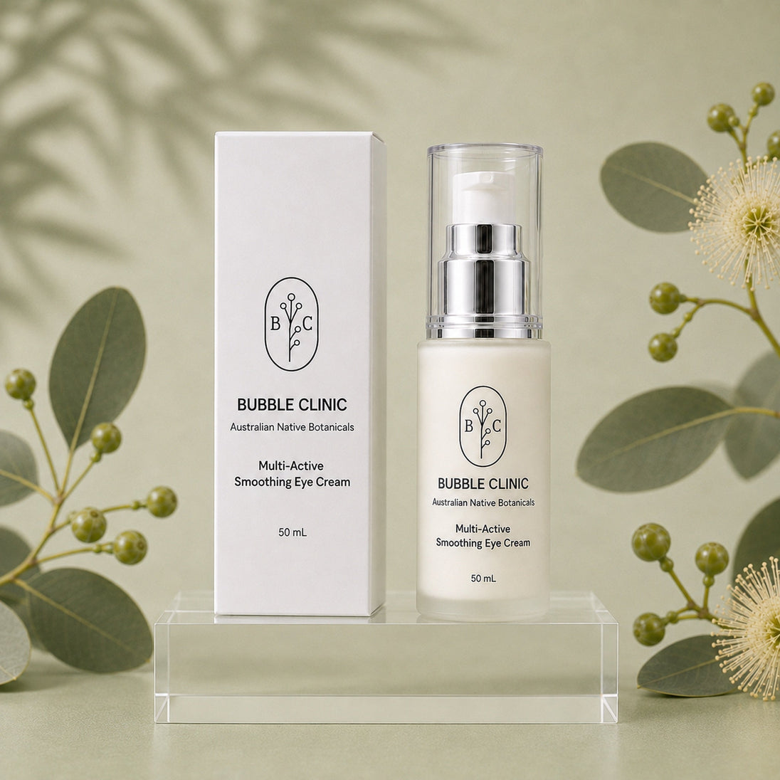 Bubble Clinic Multi-Active Smoothing Eye Cream 50 mL with matching carton on clear acrylic pedestal and muted sage Australian botanical backdrop