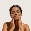 natural pore minimising cleansing oil being applied to face. Evident is Siliky smooth textrue, lightweight and powerful in removing grime and waterproof makeup.