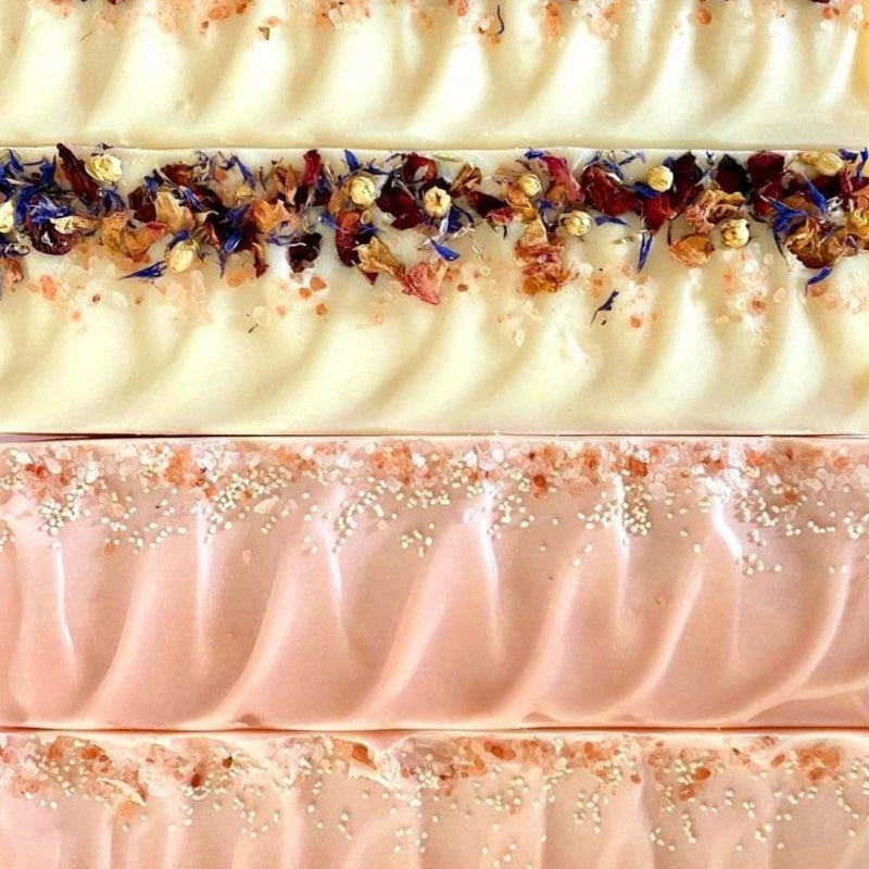 close up of natural soap loaves with botanicals, organic oils and butters and fragranced with essential oils.