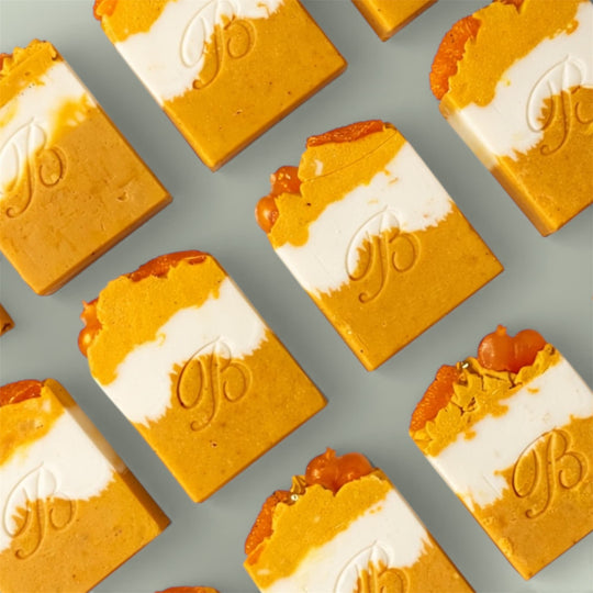 Handmade Kojic Acid Niacinamide Turmeric Soap for hyperpigmentation, acne prone skin and uneven skin tone – Australian made flat laid on green surface