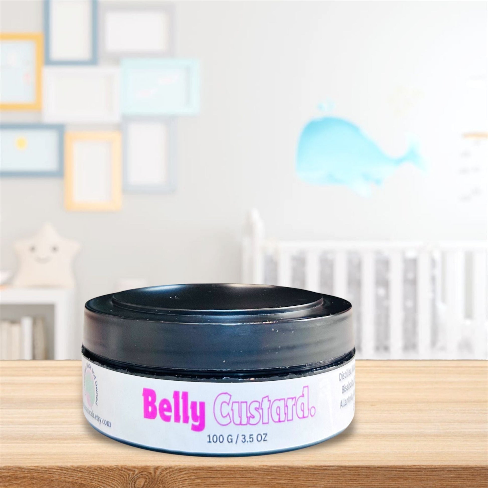 Belly custard jar on an organic wood table, set against a serene baby nursery backdrop featuring a cot, change table, and charming baby decor.
