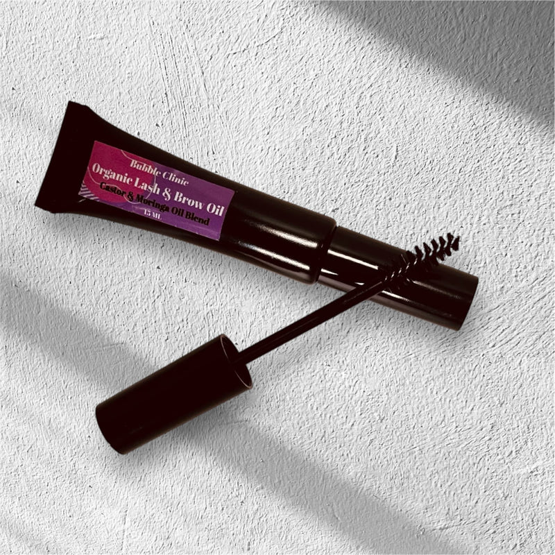 Close-up of Lash & Brow Conditioning Oil tube and applicator brush