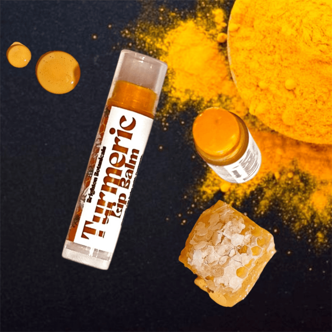 close up of brightening turmeric lip balm with organic honey and turmeric against dark background to highlight beautiful natural colour of organic turmeric and honey.