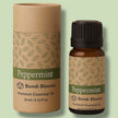 Peppermint essential oil bottle and packaging on a light green background representing best therapeutic grade essential oils Australia.