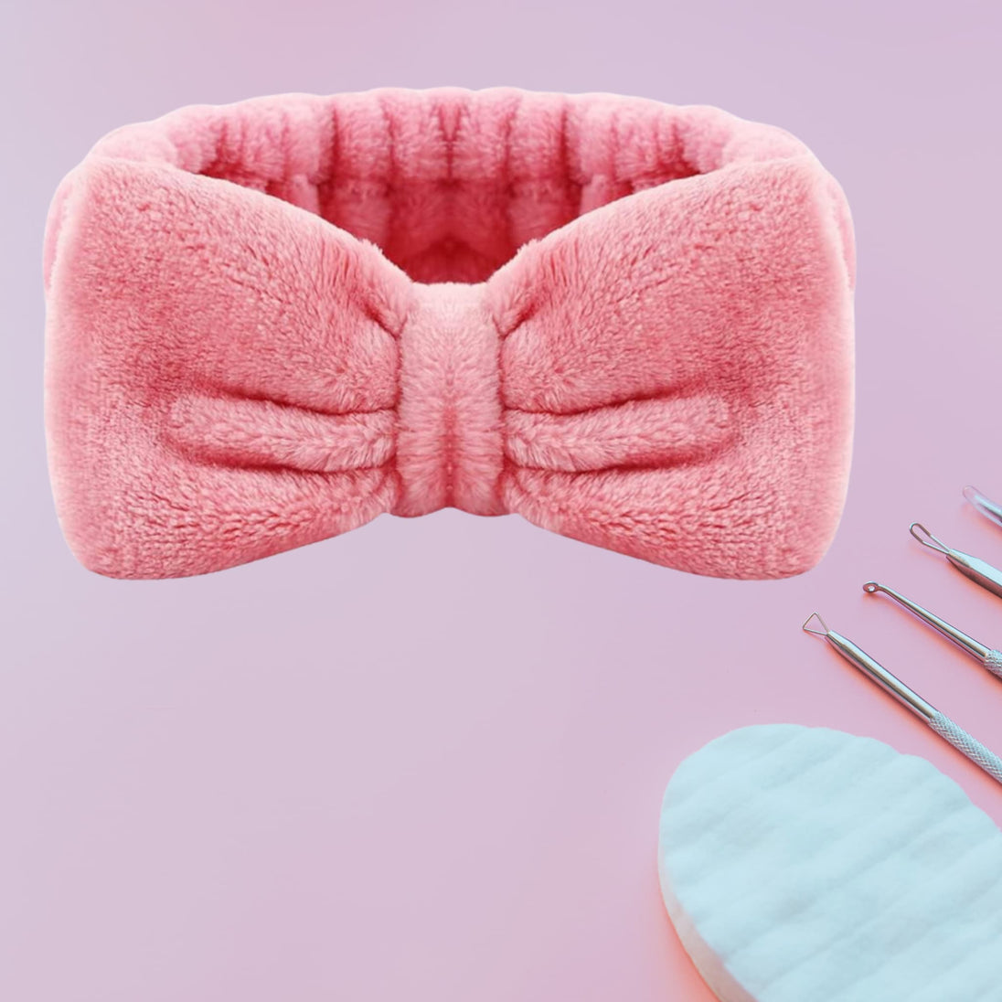 close up of original, adult size spa headband in pink against pink background with skincare essentials. 