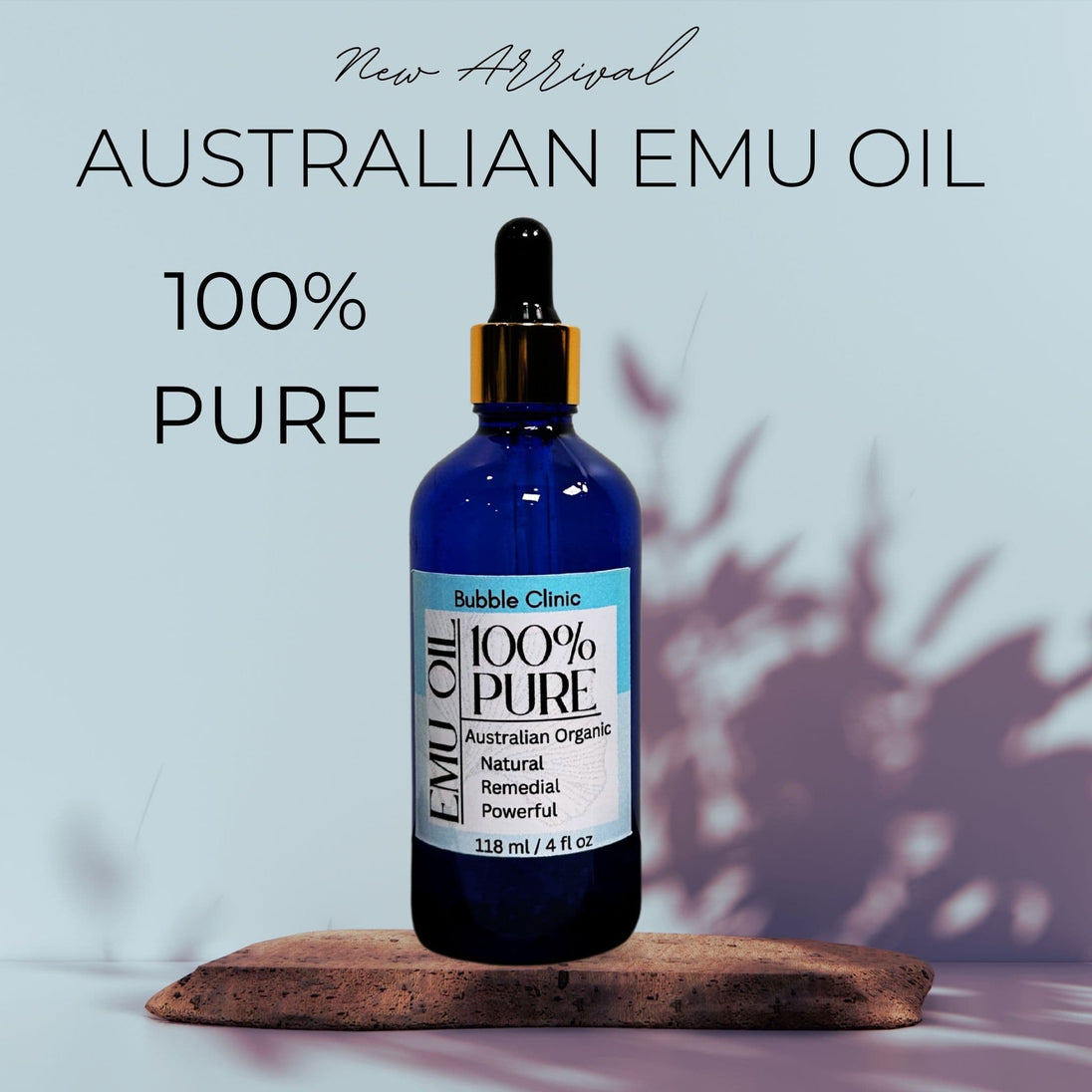 Pure Australian Emu Oil in Blue Glass Serum Bottle ith leafy shadows in the background and text "Australian Emu Oil - 100% Pure"