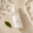 Flat lay of Bubble Clinic Radiance Peptide Serum in a 50 mL frosted bottle