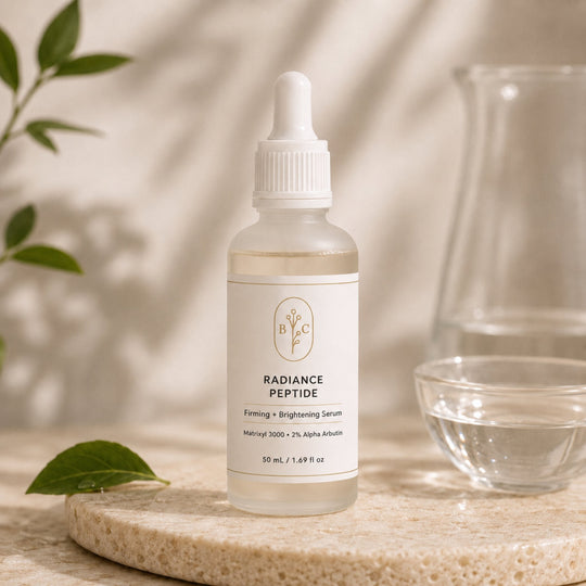 Bubble Clinic Radiance Peptide Serum in a filled 50 mL frosted dropper bottle on a beige background and stone surface.