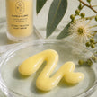Creamy milky texture of Bubble Clinic Retinol Tri-Active Night Serum with frosted 50 mL bottle and Australian botanical styling