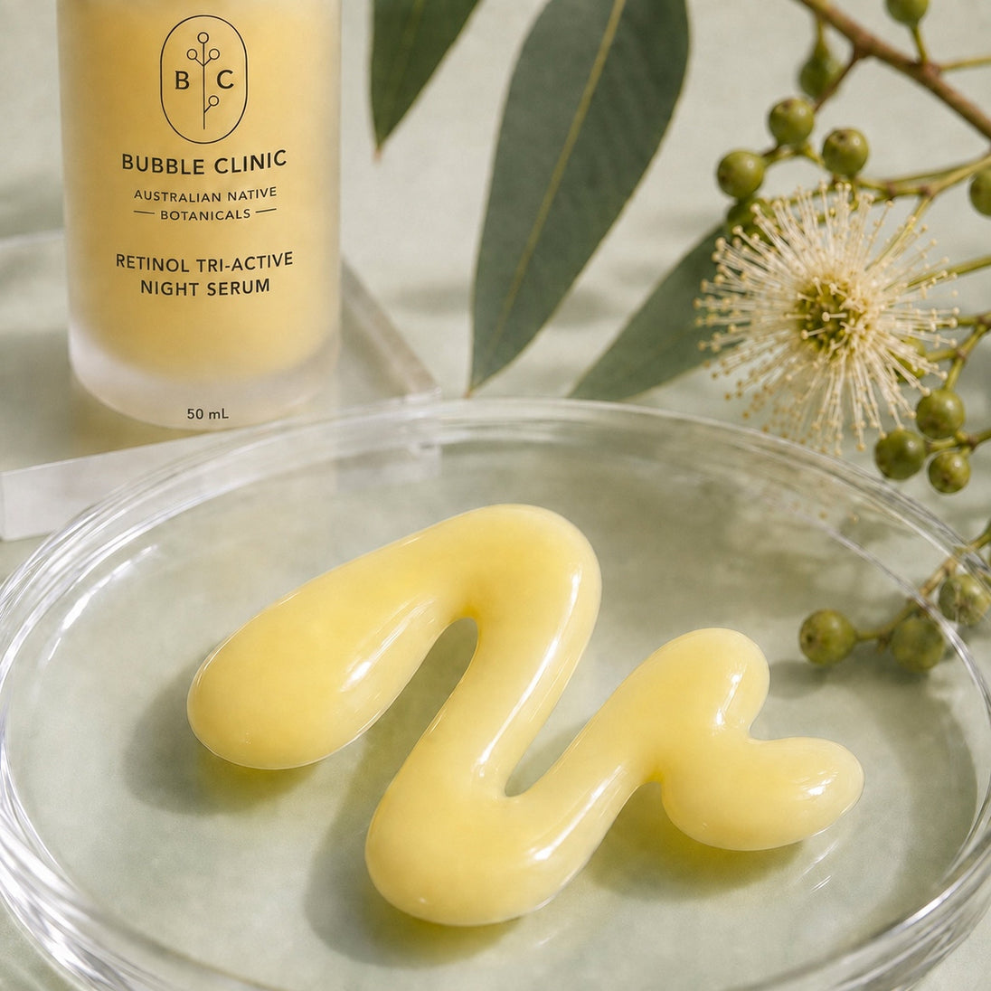 Creamy milky texture of Bubble Clinic Retinol Tri-Active Night Serum with frosted 50 mL bottle and Australian botanical styling