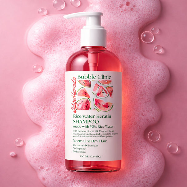 Bottle of Bubble Clinic Rice Water Keratin Shampoo on a pink background with bubbles