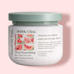 Jar of Bubble Clinic rice water, keratin, biotin hair treatment mask with watermelon slices on a pink background representing best hair mask for growth, shine and hair repair.