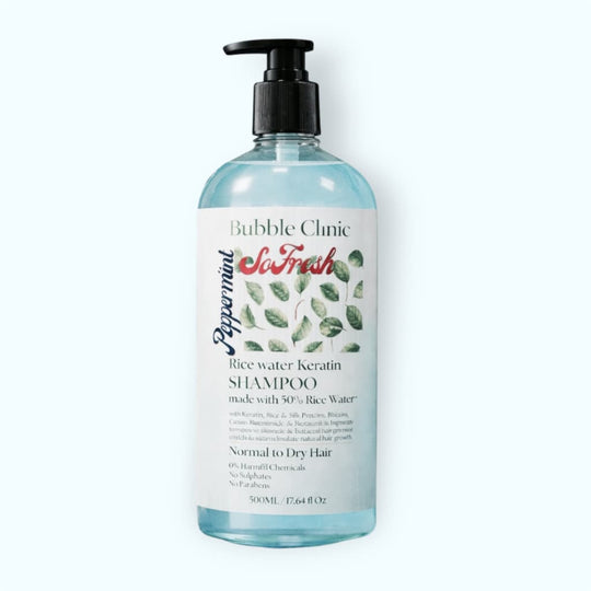 Bottle of Bubble Clinic Peppermint rice watrer and keratin shampoo for damaged and chemically treated hair on a white background
