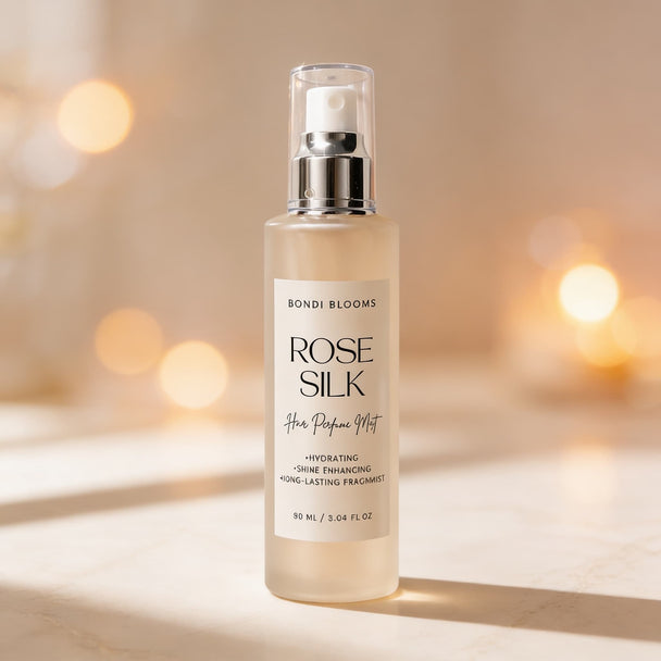 Bondi Blooms Rose Silk hair perfume mist bottle on a blurred background