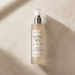 Bottle of rose silk hair perfume mist on a beige marble surface representing best hair perfume australia.