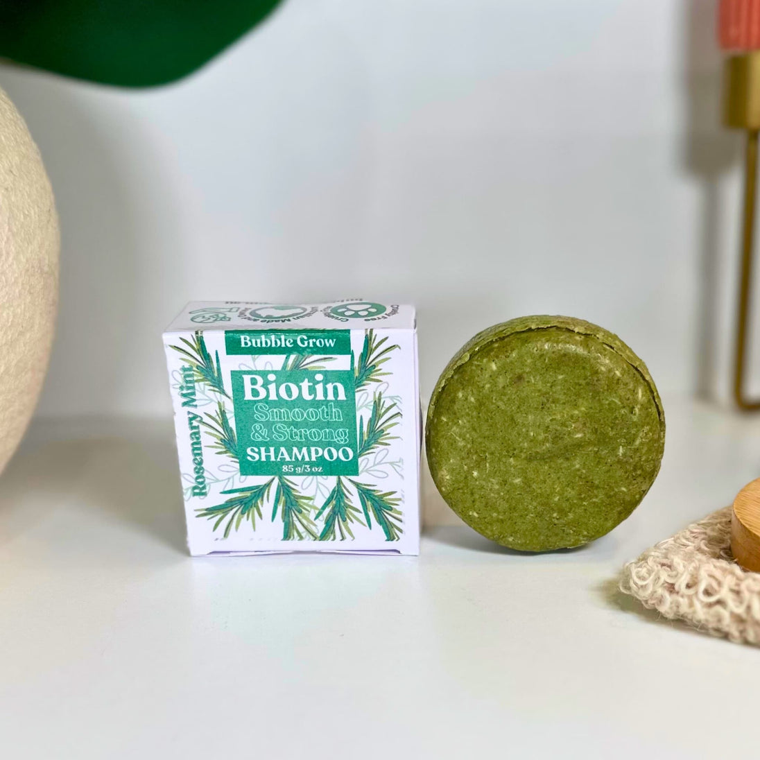 solid shampoo bar gently cleanses with coconut-derived surfactants. round, green pictured with quality packaging against white background representing clean organic australian haircare.