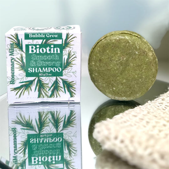 close up round green natural shampoo bar with biotin, rosemary, spirulina, moringa, amla oil on a mirror tray with sisal soap and green and white packaging representing the best in Australian haircare.