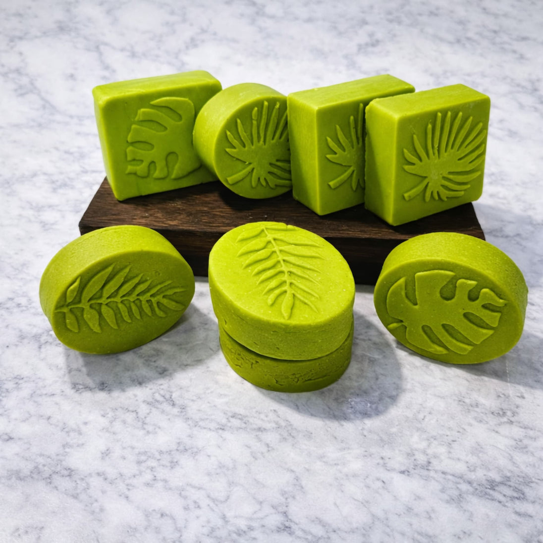 multiple sulfur cleanser bars with salicylic acid on light marble bench representing best cleansing bars for oily blemish prone skin.