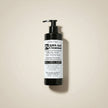 BHA charcoal Gel Cleanser with tea tree bottle on a beige background representing best deep pore cleanser with salicylic acid.
