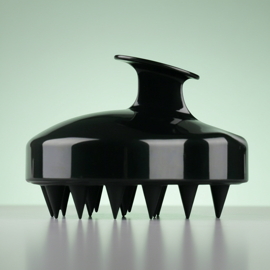 Black silicone soft scalp massager on a gray background