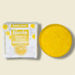close up of yellow, turmeric biotin shampoo bar Turmeric & Rice Protein  Helps smooth frizz, tame flyaways, and promote shine while supporting scalp balance. with no nasty chemicals or sulfates