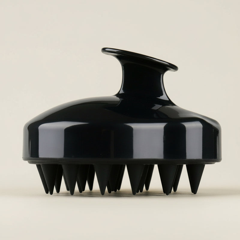 Black silicone scalp massage brush shown as a separate haircare accessory