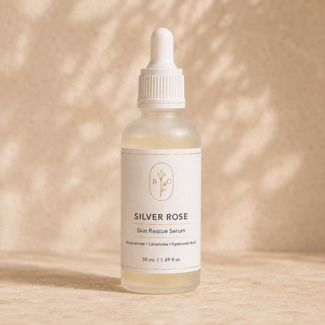 Bubble Clinic Silver Rose Skin Rescue Serum in a frosted 50 mL dropper bottle with niacinamide, ceramides and hyaluronic acid, styled with rose petals and daisies on a warm neutral background.