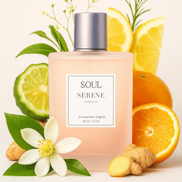 Bottle of soul serene aromatherapy citrus woody perfume with essential oils surrounded by fruits and botanicals representing the natural fragrance notes in the Australian aromatherapy perfume.