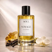Perfume bottle labeled 'Soul Voyage' with vanilla beans and an orchid on a reflective surface representing best australian original luxury perfume with essential oils.