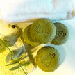 close up - top view emu oil sulphur soap bars with eucalyptus leaves in the foreground representing natural treatments for acne and troubled skin.