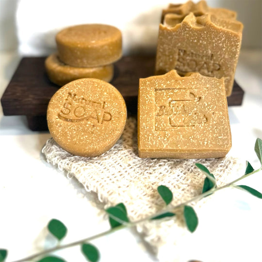 close up of two sizes of emu oil sulphur soap with emu oil and msm with botanicals and natural sisal soap saver in foreground representing all natural Australian Acne and Rosacea skincare.