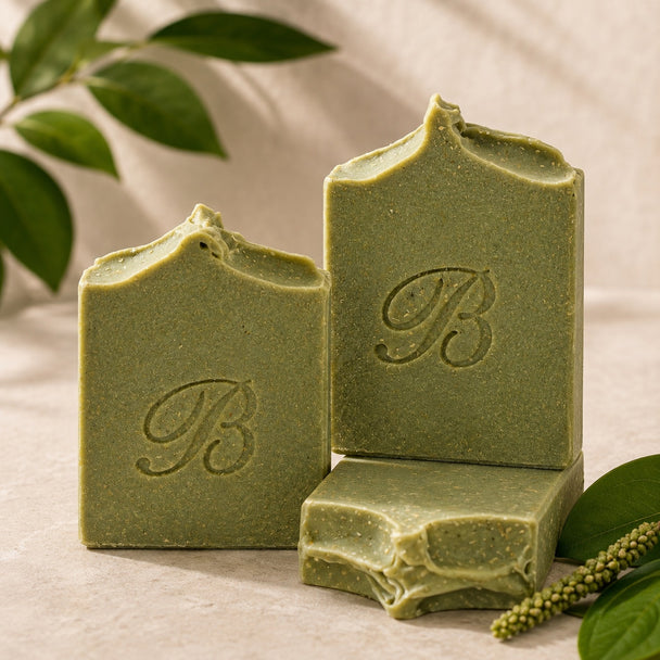 Three-view arrangement of handmade sulphur soap with plantain and comfrey, showing front, top and side texture.