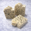 Three sulphur terrazzo-style soap bars with a textured surface for blemishes and troubled skin with a brand logo on a marble surface representing natural Australian skincare for blemishes and troubled skin