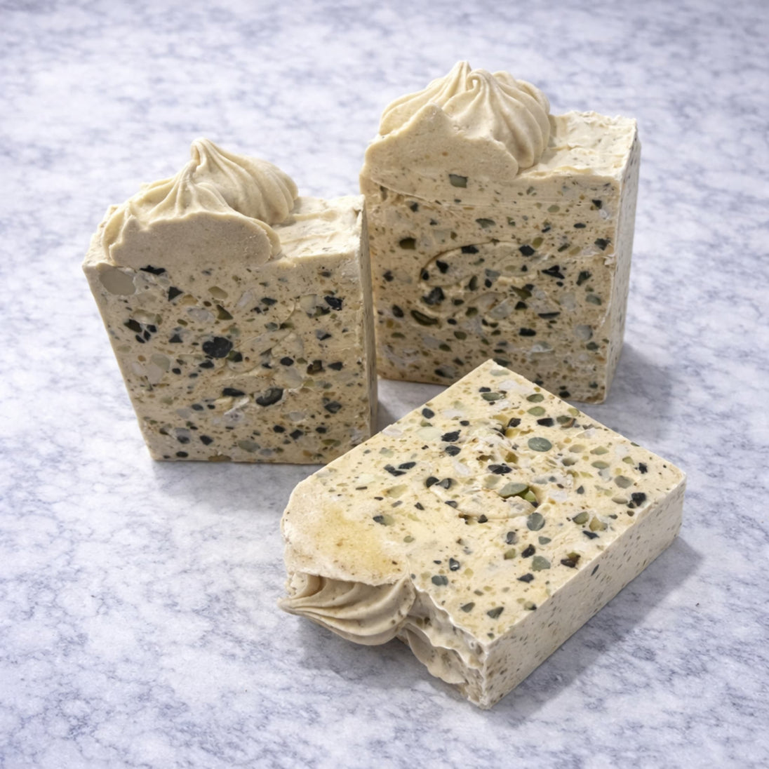 Three sulphur terrazzo-style soap bars with a textured surface for blemishes and troubled skin with a brand logo on a marble surface representing natural Australian skincare for blemishes and troubled skin