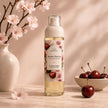 Sweet Cherry Body Mist by Bubble Clinic styled with cherries and soft pink blossoms